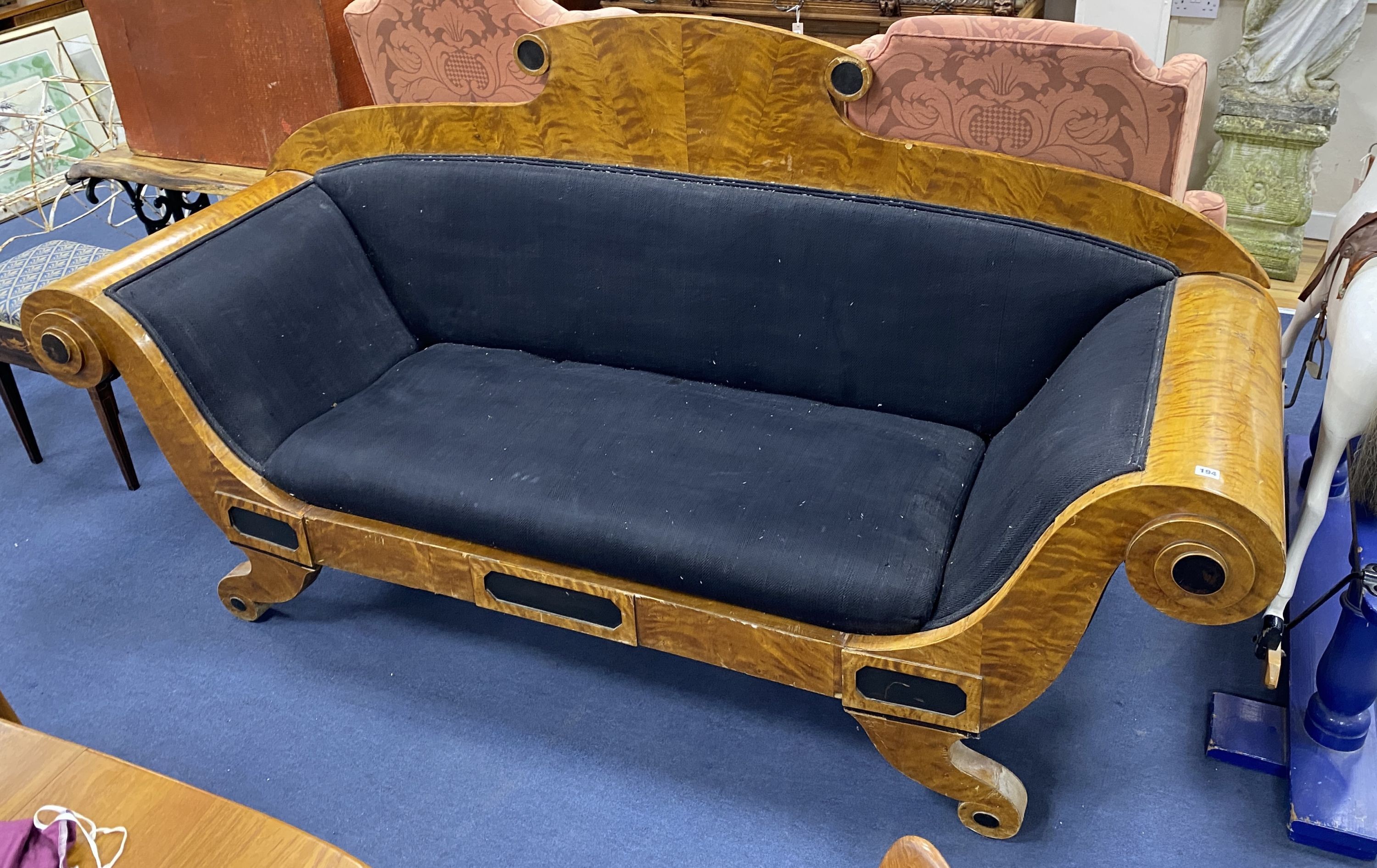 A Biedermeier style part ebonized birch scroll arm settee upholstered in black fabric width 230, depth 78, height 121cm